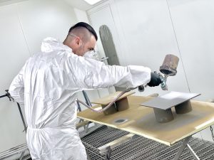 a specialist performing industrial paint spraying