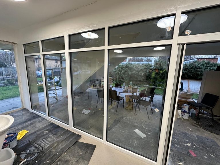 White curtain wall frames in a Chelmsford building before spraying